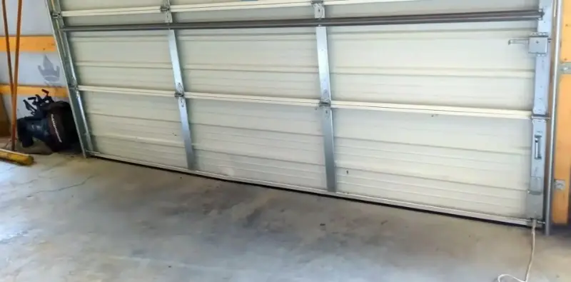 Bent and damaged garage door panel in Myrtle Beach before replacement