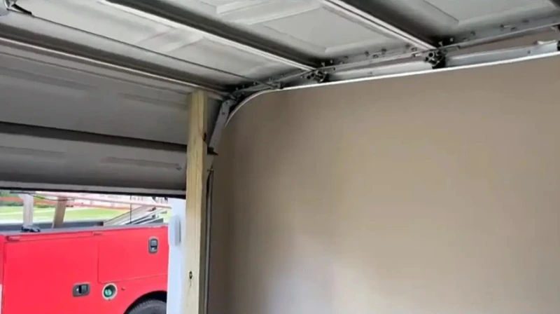 Residential garage door off its track in Myrtle Beach before repair